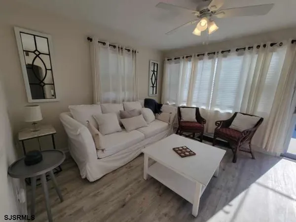 a living room with furniture a rug and a window