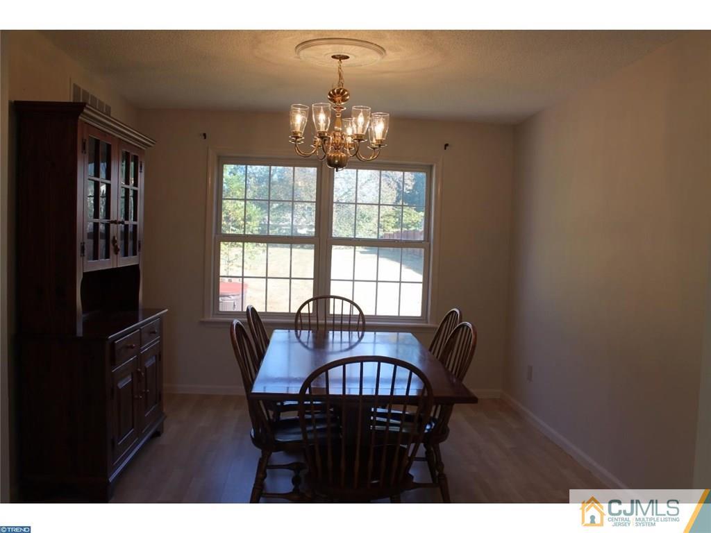 460 Flock Road Hamilton, NJ 08619 - Photo 3 of 25 a view of a dining room with furniture a chandelier and window