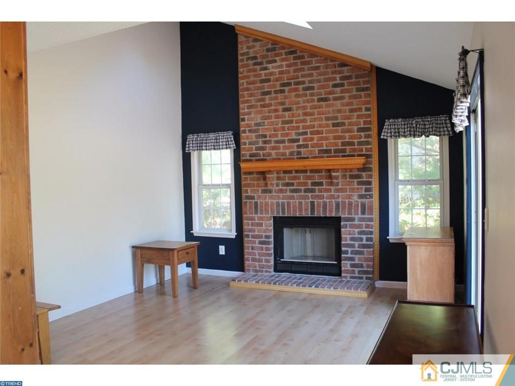 460 Flock Road Hamilton, NJ 08619 - Photo 5 of 25 a living room with a fireplace and a wooden floor