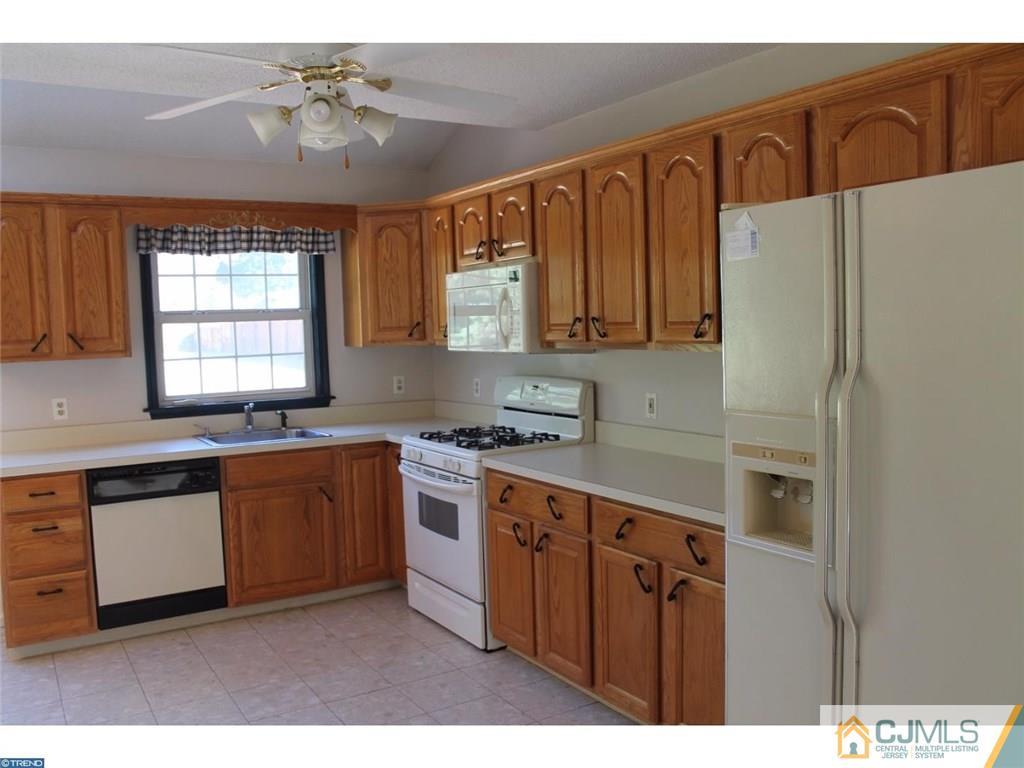 460 Flock Road Hamilton, NJ 08619 - Photo 7 of 25 a kitchen with stainless steel appliances granite countertop a refrigerator a sink dishwasher a stove with wooden cabinets