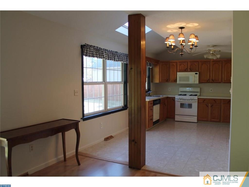 460 Flock Road Hamilton, NJ 08619 - Photo 8 of 25 a kitchen with granite countertop a stove a sink and a microwave