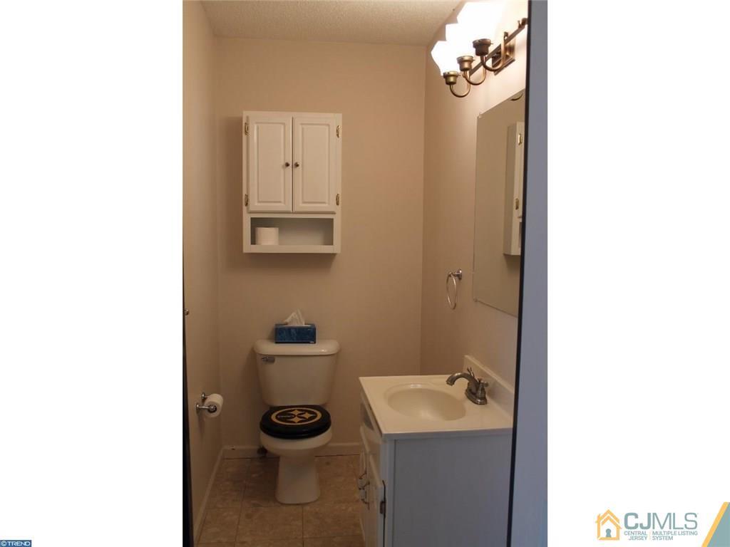 460 Flock Road Hamilton, NJ 08619 - Photo 9 of 25 a bathroom with a sink toilet and mirror