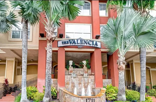 a view of a house with a palm tree