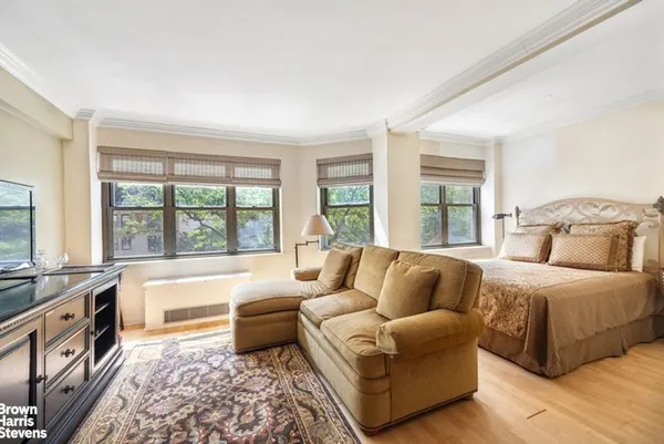 a spacious bedroom with a large bed and a large window