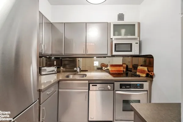 a kitchen with stainless steel appliances a sink stove and cabinets