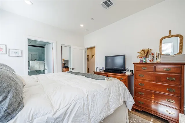 a bathroom with a granite countertop sink a toilet and a mirror