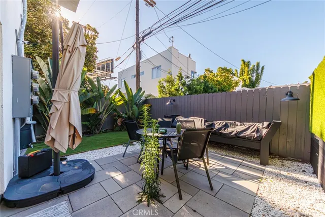 a view of a patio with table and chairs and potted plants