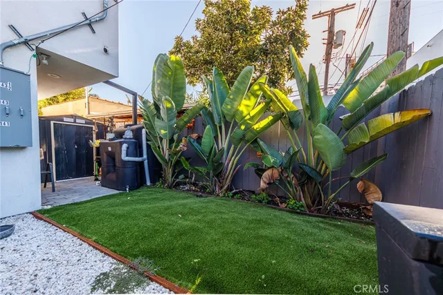 a view of a patio with table and chairs potted plants and wooden floor