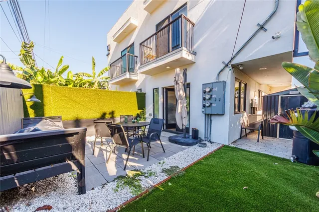 a view of a patio with table and chairs with potted plants