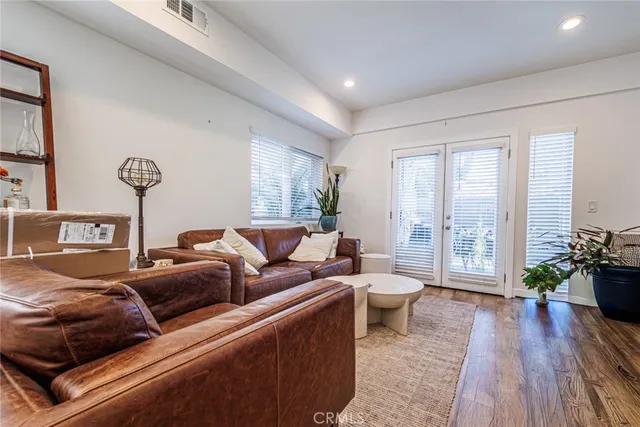 a living room with stainless steel appliances kitchen island granite countertop furniture and a kitchen view