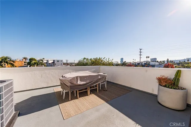 a terrace with outdoor seating and city view