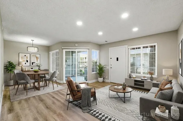 a living room with furniture and large windows
