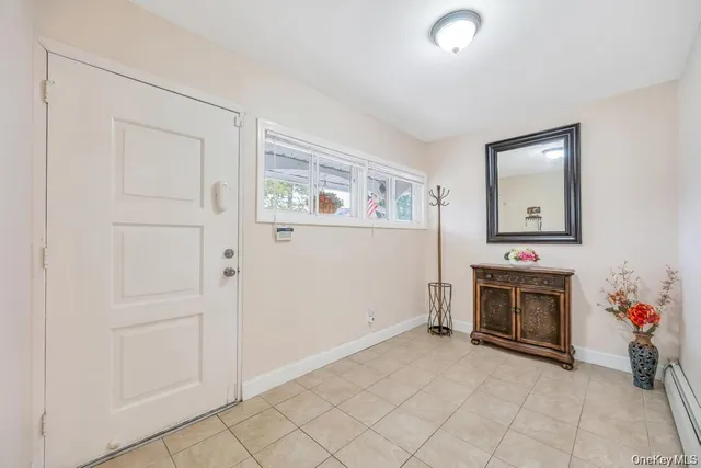 an empty room with windows dryer and fireplace