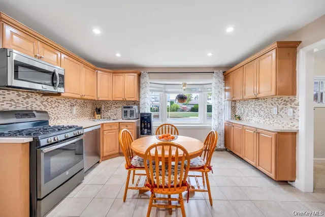 a kitchen with granite countertop wooden cabinets and stainless steel appliances