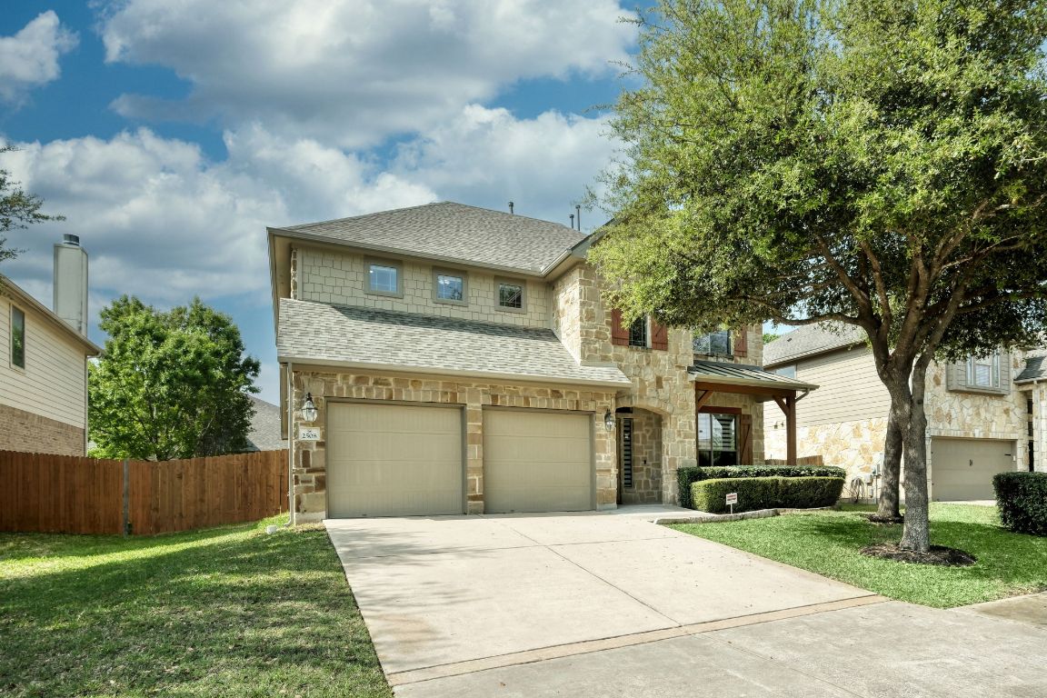 2508 Mirasol Loop Round Rock, TX 78681 - Photo 1 of 28 a front view of a house with a garden and a tree