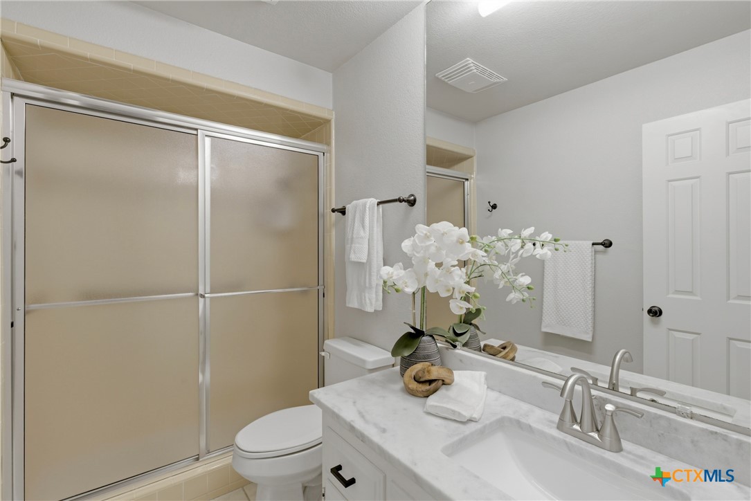1710 Old Mill Road, Unit 12 Salado, TX 76571 - Photo 30 of 42 a bathroom with a sink toilet and shower
