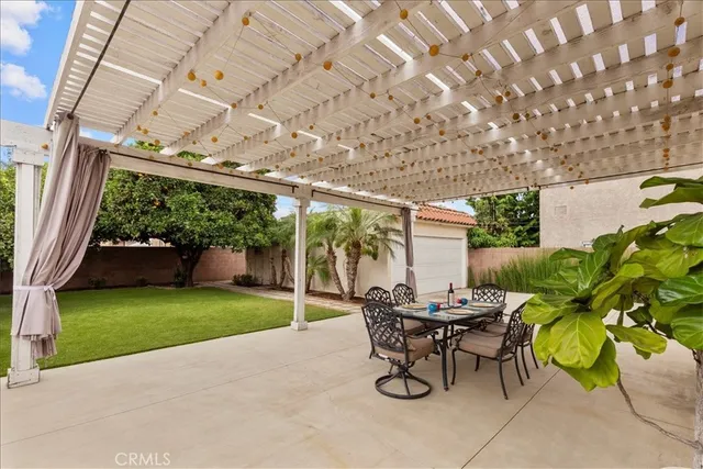 a view of a patio with table and chairs and potted plants