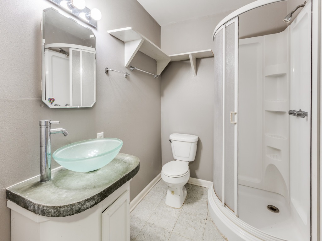 423 South Main Street Lockhart, TX 78644 - Photo 13 of 21 a bathroom with a toilet sink and shower