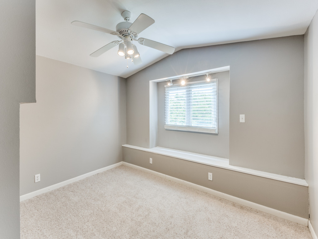 423 South Main Street Lockhart, TX 78644 - Photo 14 of 21 an empty room with a chandelier fan and windows