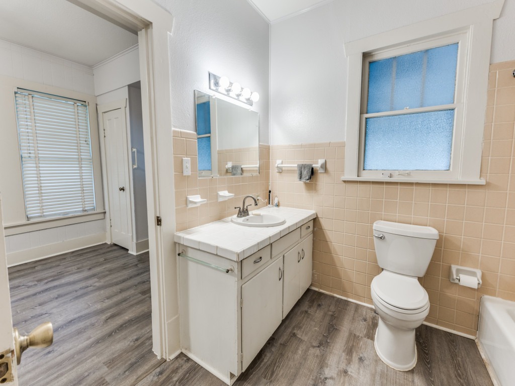 423 South Main Street Lockhart, TX 78644 - Photo 15 of 21 a bathroom with a toilet sink and mirror