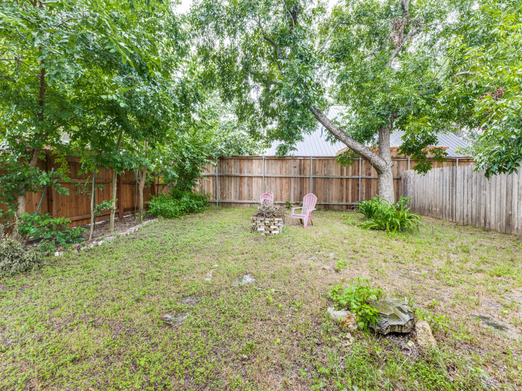 423 South Main Street Lockhart, TX 78644 - Photo 18 of 21 a view of a backyard with a small cabin and wooden fence
