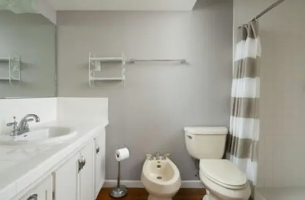 a white toilet sitting next to a bathroom sink