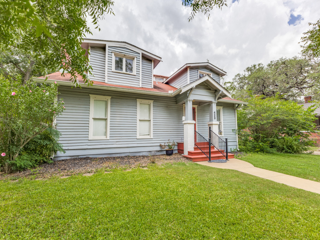 423 South Main Street Lockhart, TX 78644 - Photo 3 of 21 a front view of a house with a yard and garage