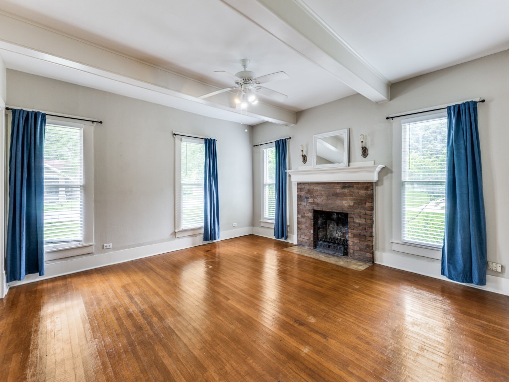 423 South Main Street Lockhart, TX 78644 - Photo 4 of 21 a view of an empty room with wooden floor fireplace and a window