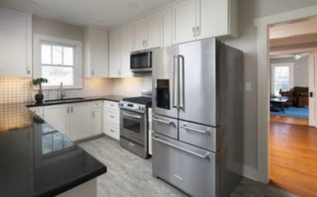 a kitchen with a refrigerator stove and sink