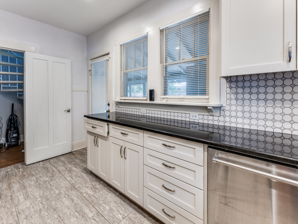 423 South Main Street Lockhart, TX 78644 - Photo 7 of 21 a kitchen with granite countertop white cabinets and a sink