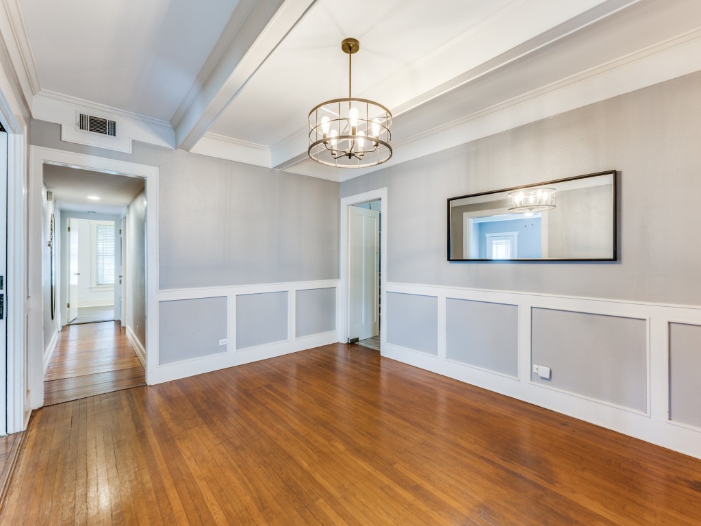 423 South Main Street Lockhart, TX 78644 - Photo 8 of 21 a view of an empty room with wooden floor and kitchen
