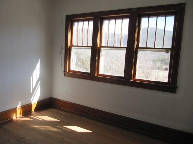 2059 Burkette Road Elliston, VA 24087 - Photo 15 of 18 a view of an empty room with wooden floor and a window