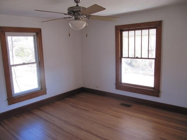 2059 Burkette Road Elliston, VA 24087 - Photo 5 of 18 an empty room with wooden floor fan and windows