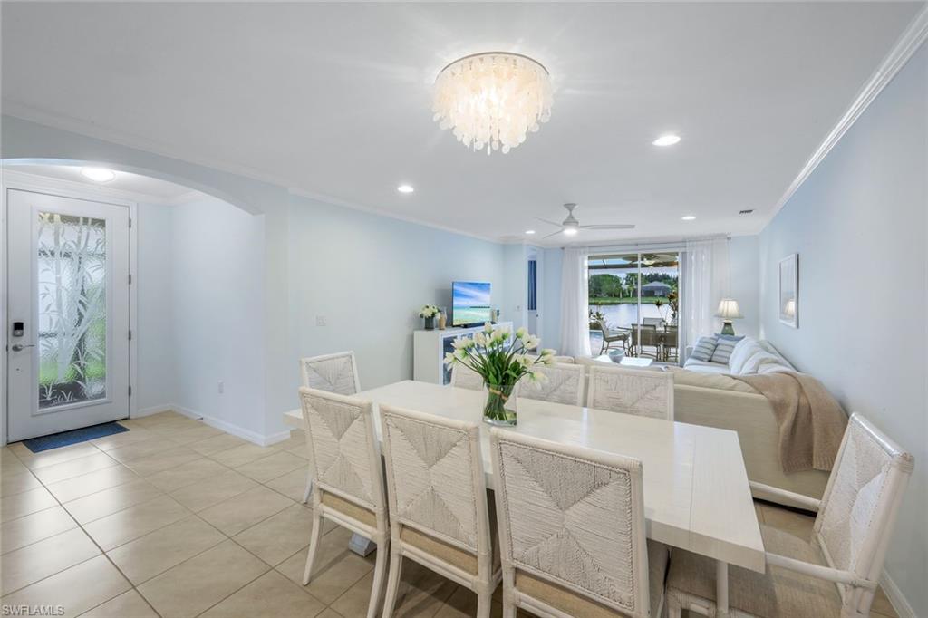 14795 Edgewater Circle Naples, FL 34114 - Photo 11 of 39 a view of a dining room with furniture and chandelier