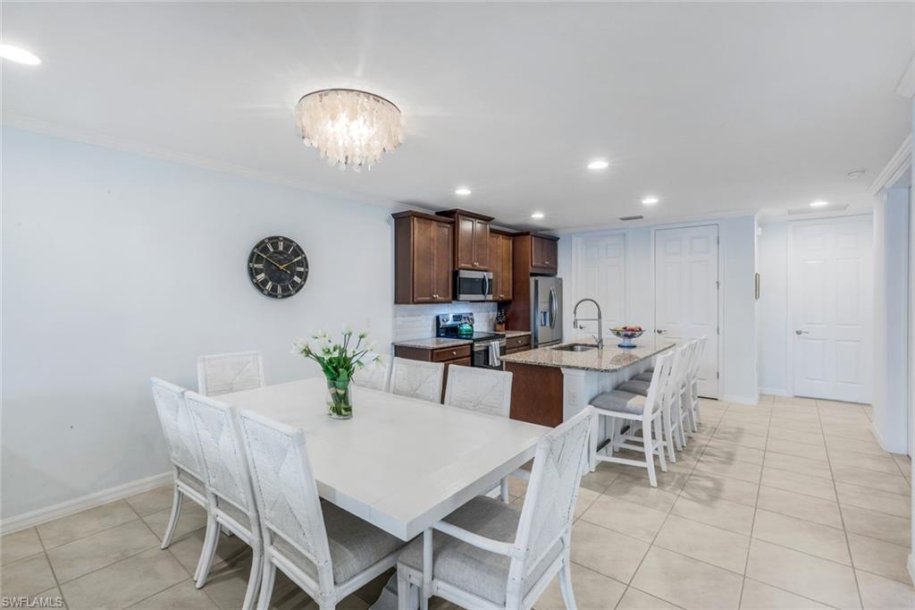14795 Edgewater Circle Naples, FL 34114 - Photo 12 of 39 a view of a dining room with furniture