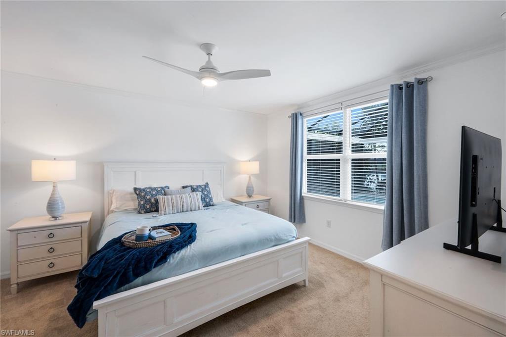 14795 Edgewater Circle Naples, FL 34114 - Photo 13 of 39 a bedroom with a bed flat screen tv and a window