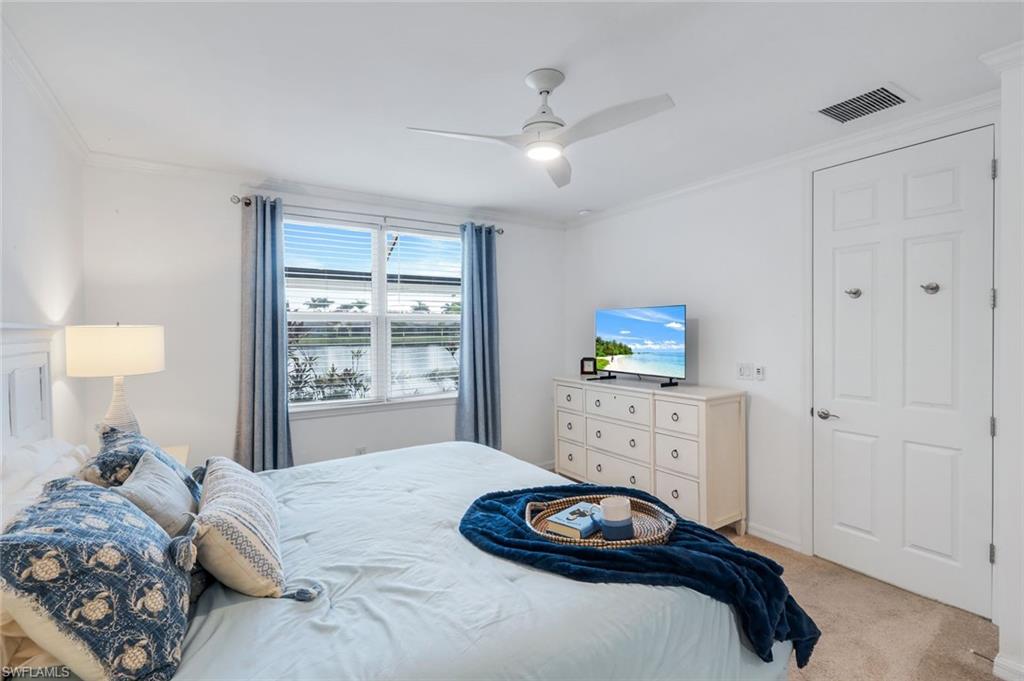 14795 Edgewater Circle Naples, FL 34114 - Photo 14 of 39 a bedroom with a bed and a window