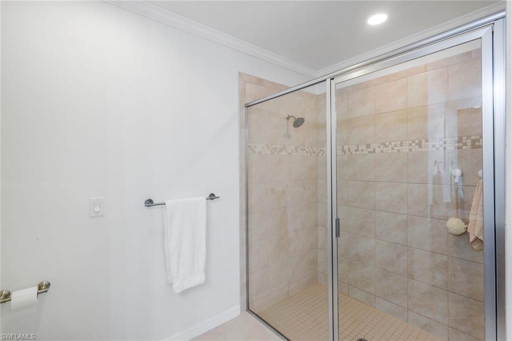 14795 Edgewater Circle Naples, FL 34114 - Photo 16 of 39 a bathroom with a glass shower door