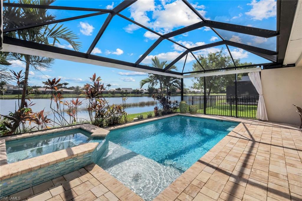 14795 Edgewater Circle Naples, FL 34114 - Photo 23 of 39 a view of a swimming pool with a patio