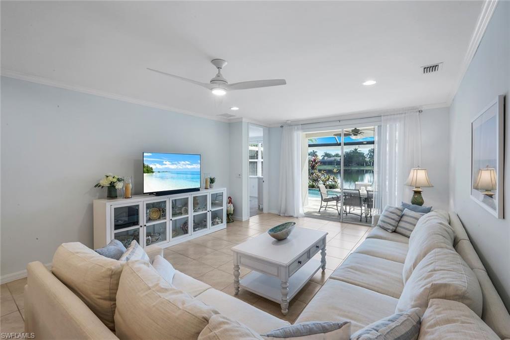 14795 Edgewater Circle Naples, FL 34114 - Photo 3 of 39 a living room with furniture and a flat screen tv