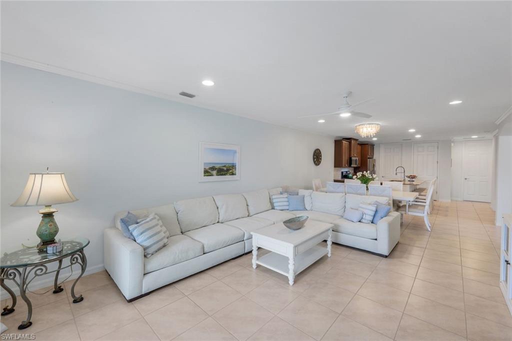 14795 Edgewater Circle Naples, FL 34114 - Photo 5 of 39 a living room with furniture and a potted plant