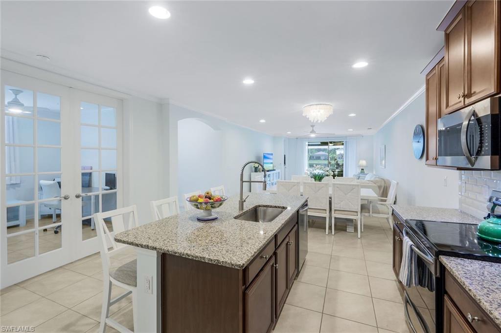 14795 Edgewater Circle Naples, FL 34114 - Photo 9 of 39 a view of a dining room with furniture