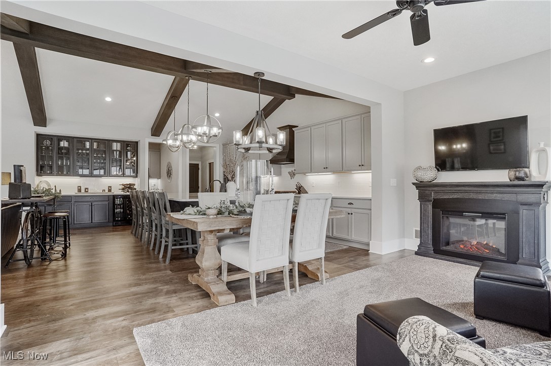 4437 Beach Road Medina, OH 44256 - Photo 14 of 50 Dining room featuring bar, vaulted ceiling with beams, hardwood / wood-style floors, and ceiling fan
