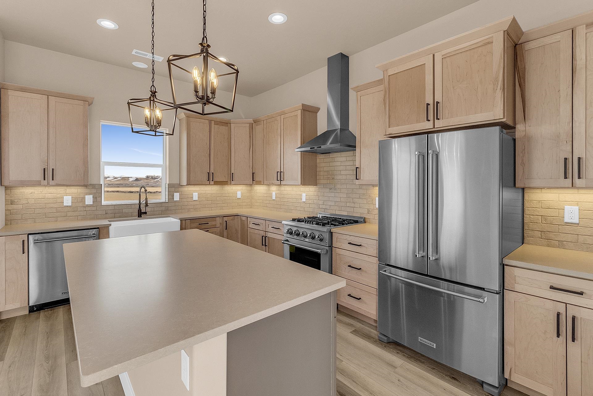 1656 8 Road Mack, CO 81525 - Photo 11 of 28 a kitchen with stainless steel appliances a refrigerator sink and wooden floor