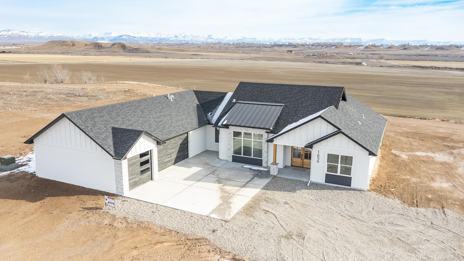 1656 8 Road Mack, CO 81525 - Photo 22 of 28 a view of a house with a lake and mountain view