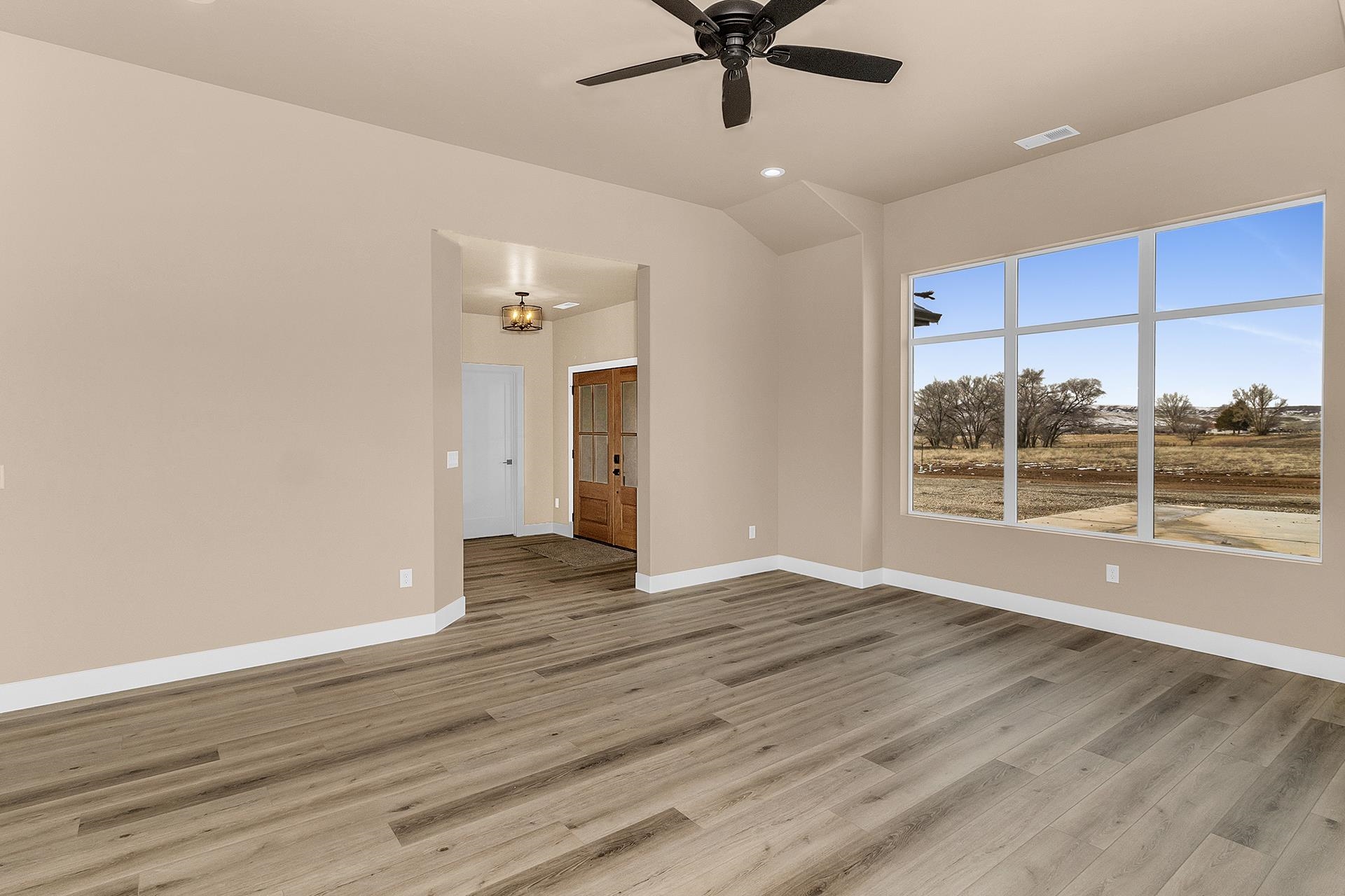 1656 8 Road Mack, CO 81525 - Photo 9 of 28 an empty room with wooden floor and windows