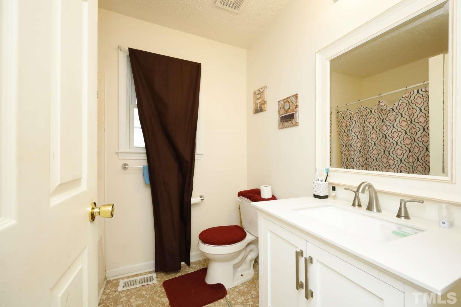 802 South Webb Street Selma, NC 27576 - Photo 12 of 25 a bathroom with a sink toilet and shower