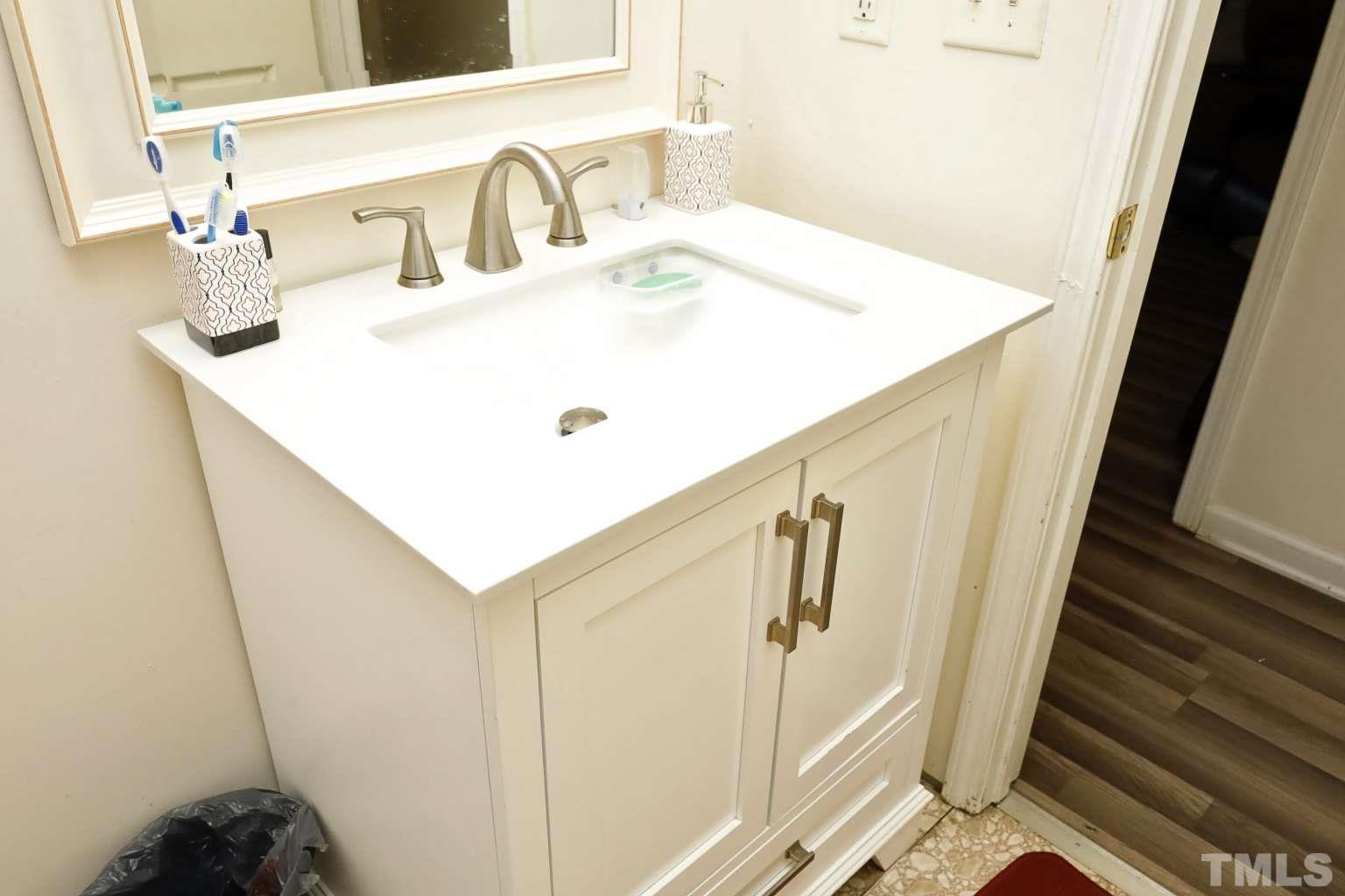 802 South Webb Street Selma, NC 27576 - Photo 13 of 25 a bathroom with a sink and mirror
