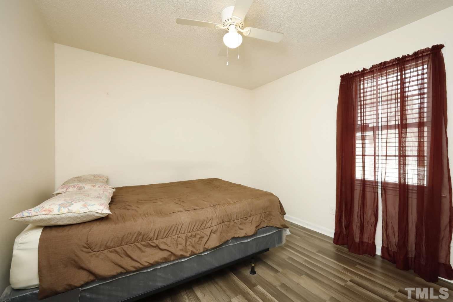 802 South Webb Street Selma, NC 27576 - Photo 15 of 25 a bedroom with a bed and a window