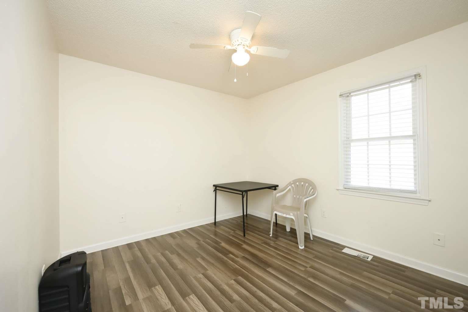 802 South Webb Street Selma, NC 27576 - Photo 17 of 25 a view of a room with wooden floor and a ceiling fan